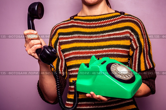 Young woman answering old rotary phone. Стоковое фото, агентство Ingram Publishing / Фотобанк Лори