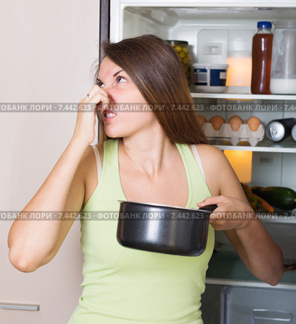 Young woman holding foul food. Стоковое фото, фотограф Яков Филимонов / Фотобанк Лори