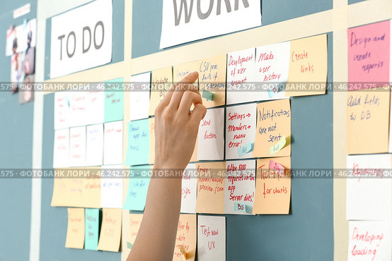 Young woman near scrum task board in office. Стоковое фото, фотограф Pixel_shot / Фотобанк Лори