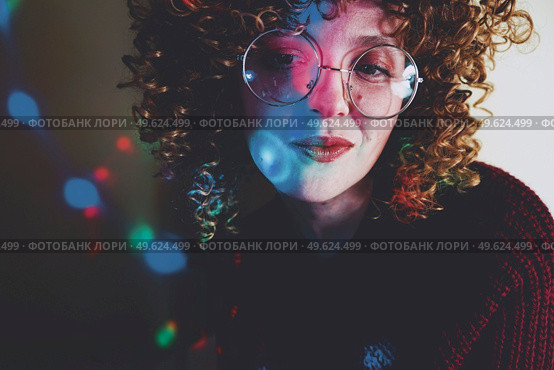 Young woman portrait illuminated by psychedelic lights. Стоковое фото, агентство Ingram Publishing / Фотобанк Лори