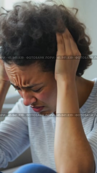 Young woman suffering from strong headache at home. Стоковое AI-видео, аниматор Юрий Поздников / Фотобанк Лори