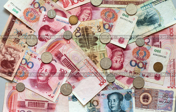 Yuan coins on heap of yuan paper money. Chinese economy and finance. Currency background. Trade relations of countries,inflation, investment, business and lending. Flat lay, closeup. Стоковое фото, фотограф Виктория Катьянова / Фотобанк Лори